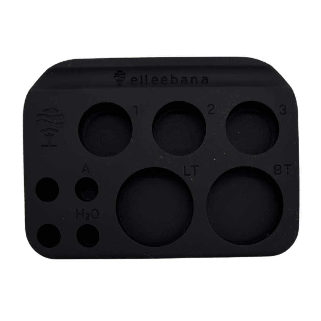 Top-down view of the pink silicone Elleebana Ellee-PALETTE featuring wells for lotions, tints, and adhesives.